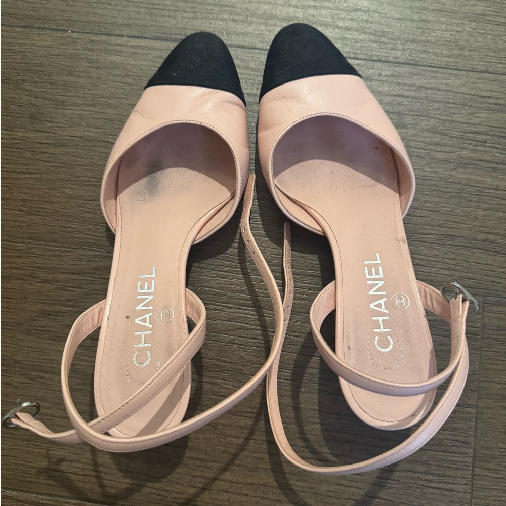 Light pink and black Chanel sling backs with ankle strap.